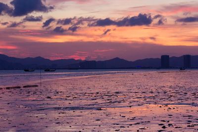 Scenic view of beach against sky during sunset
