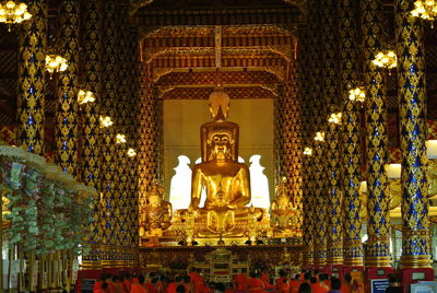 Statue of illuminated temple in building