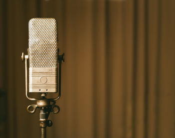 Close-up of microphone against curtain