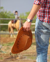 Cropped man holding hat