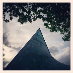 Low angle view of building against cloudy sky