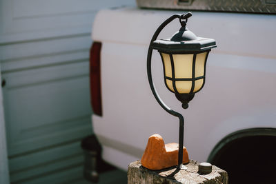 Close-up of illuminated lamp hanging against wall