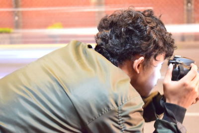 Rear view of man photographing