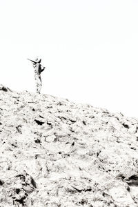 Low angle view of person standing on snow covered land