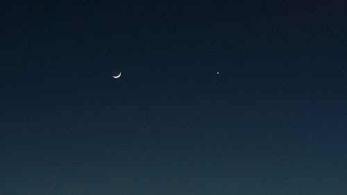 Low angle view of moon against sky at night