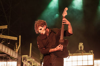 Full length of man playing guitar