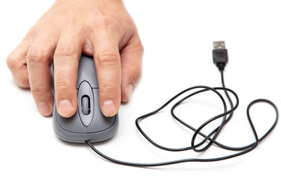 Close-up of person hand holding mobile phone over white background