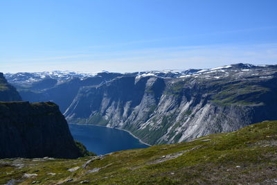 Scenic view of mountains against blue sky