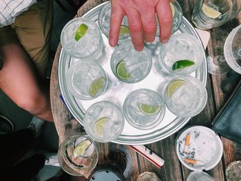 High angle view of person holding mojito in tray