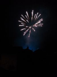 Low angle view of firework display at night