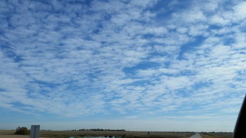 Scenic view of landscape against cloudy sky