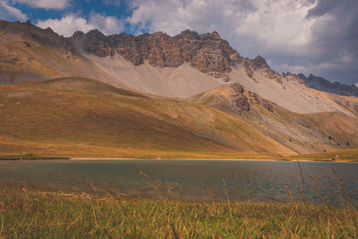 Scenic view of lake and mountains against sky