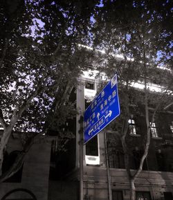 Low angle view of road sign against building