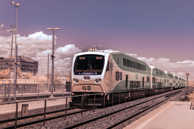 Train at railroad station against clear sky