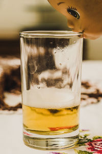 Close-up of alcoholic drink and doll on table