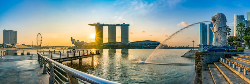 Bridge over river against sky during sunset