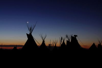 Silhouette built structure at sunset