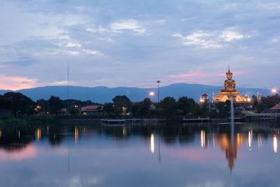 Reflection of illuminated building at sunset