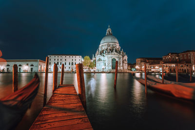 View of illuminated buildings against sky at night