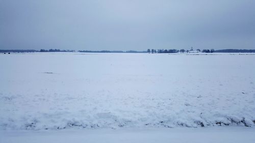 Scenic view of beach against sky during winter