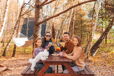 Group of people sitting in the forest