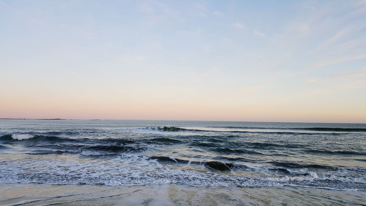 sea, water, horizon over water, beach, scenics, tranquil scene, beauty in nature, tranquility, shore, sunset, wave, sky, nature, idyllic, surf, sand, remote, outdoors, orange color, coastline