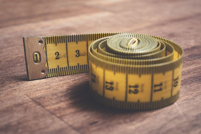 High angle view of tape measure on wooden table