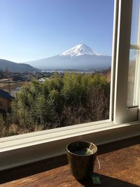 View of glass of window with mountain in background