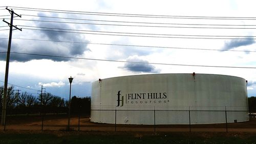 Low angle view of information sign against sky