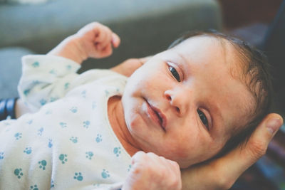 Portrait of cute baby lying on bed