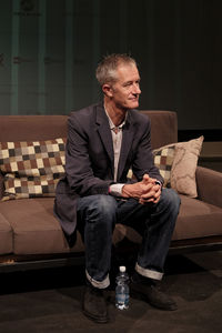 Full length of man sitting on sofa