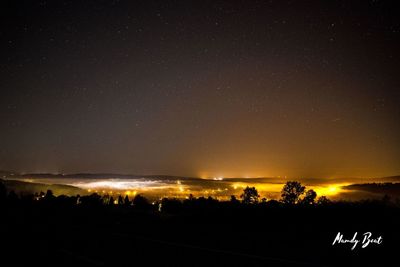 Scenic view of illuminated city against sky at night