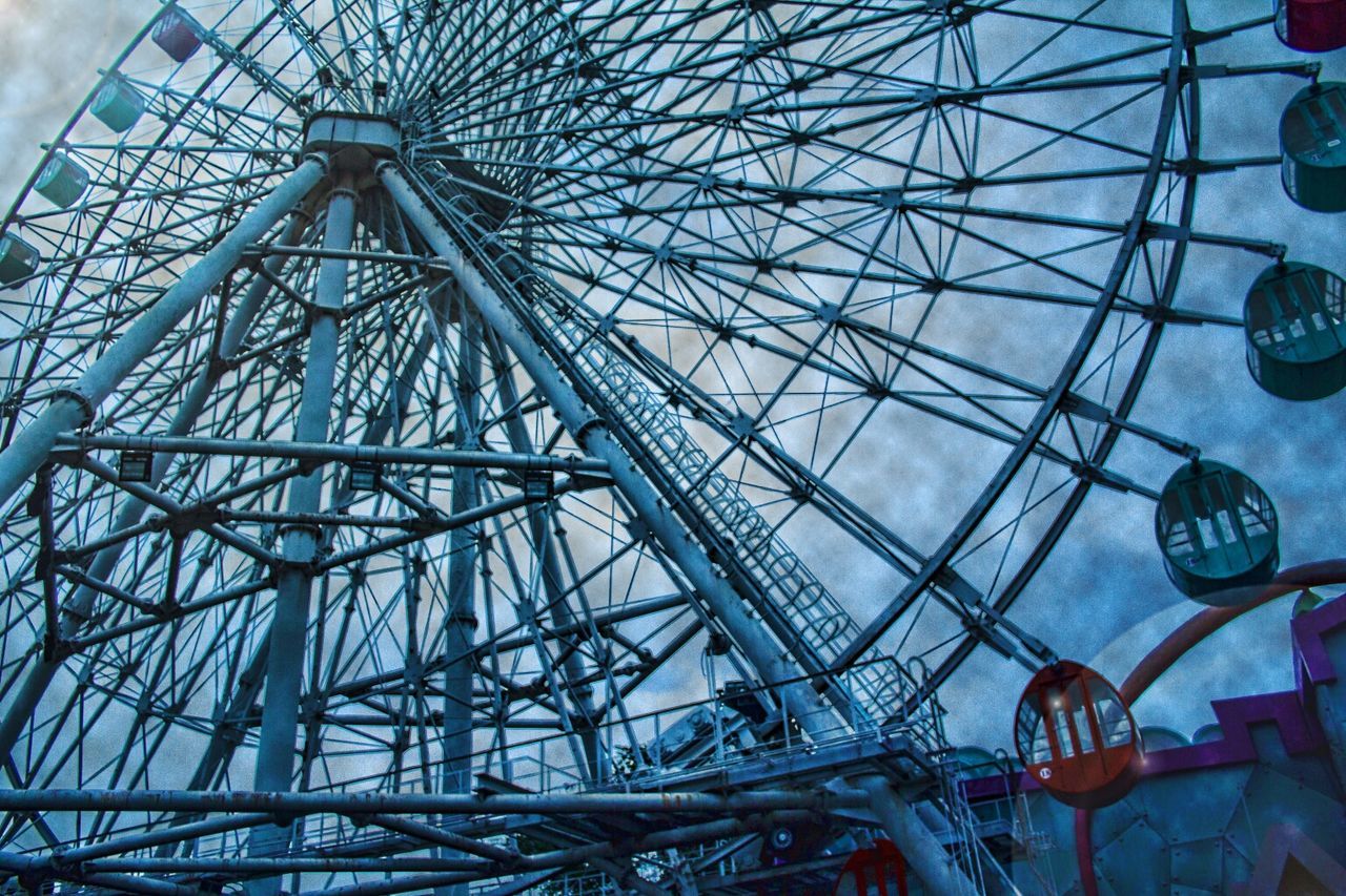 amusement park, amusement park ride, ferris wheel, low angle view, metal, arts culture and entertainment, metallic, built structure, sky, transportation, travel, architecture, day, no people, outdoors, blue, travel destinations, pattern, cloud - sky