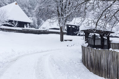 Scenic view of snow covered landscape and houses