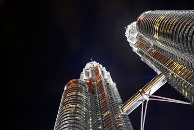 Low angle view of illuminated building against sky at night