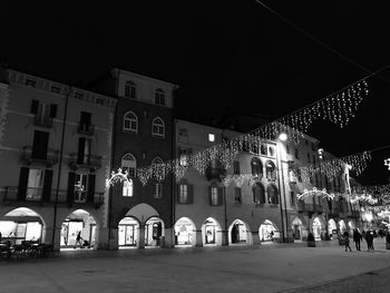 Illuminated building against sky at night