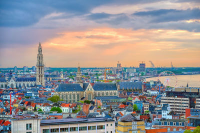 High angle view of buildings against cloudy sky