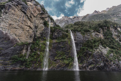 Scenic view of waterfall against sky