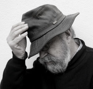 Close-up of tensed man against wall