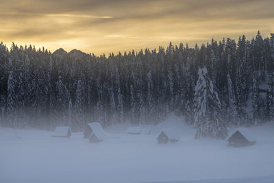 Scenic view of snow covered land against sky