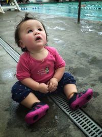 Portrait of cute baby sitting on water