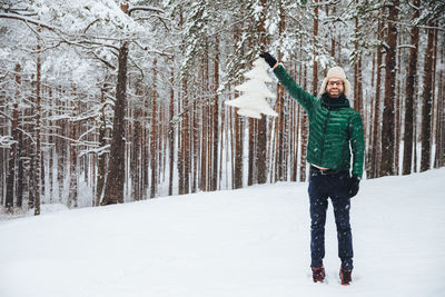 Man standing on snow covered land