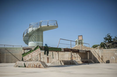 Low angle view of built structure against clear blue sky