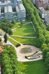 High angle view of road amidst trees and buildings in city