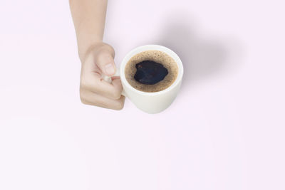 Directly above shot of woman holding coffee cup