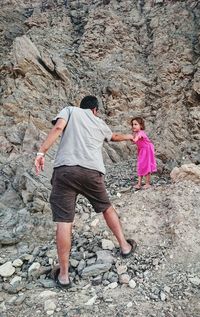 Full length of woman standing on rock