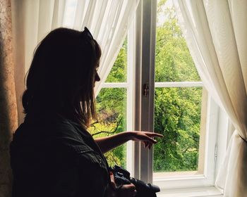 Silhouette of people looking through window