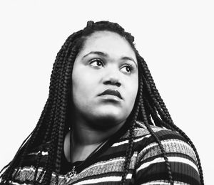 Portrait of young woman looking away against white background