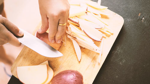 Close-up of person preparing food on cutting board