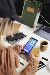 Woman's hands holding cell phone and credit card